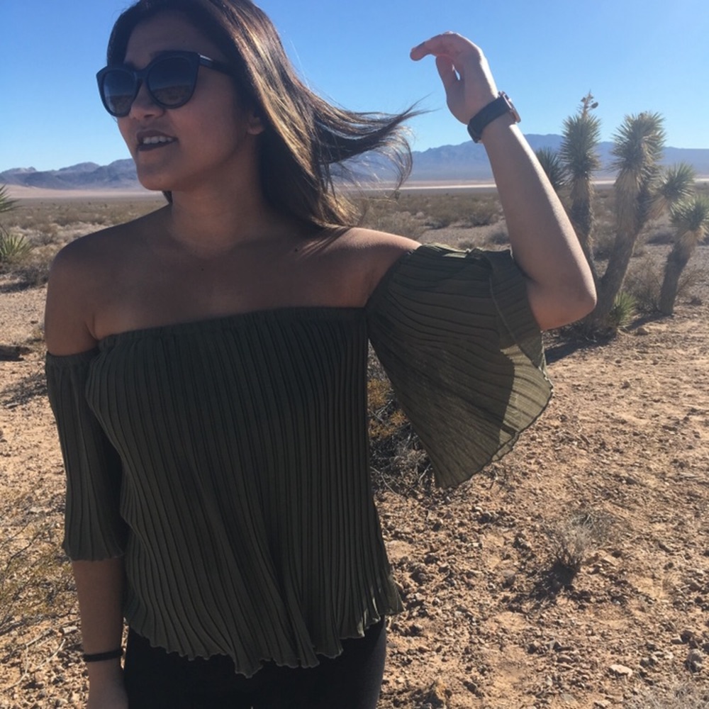 Green pleated off-the-shoulder blouse